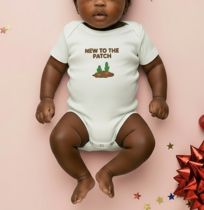 Baby wearing a onesie with 'New to the Patch' text and cactus graphics on a pink background.