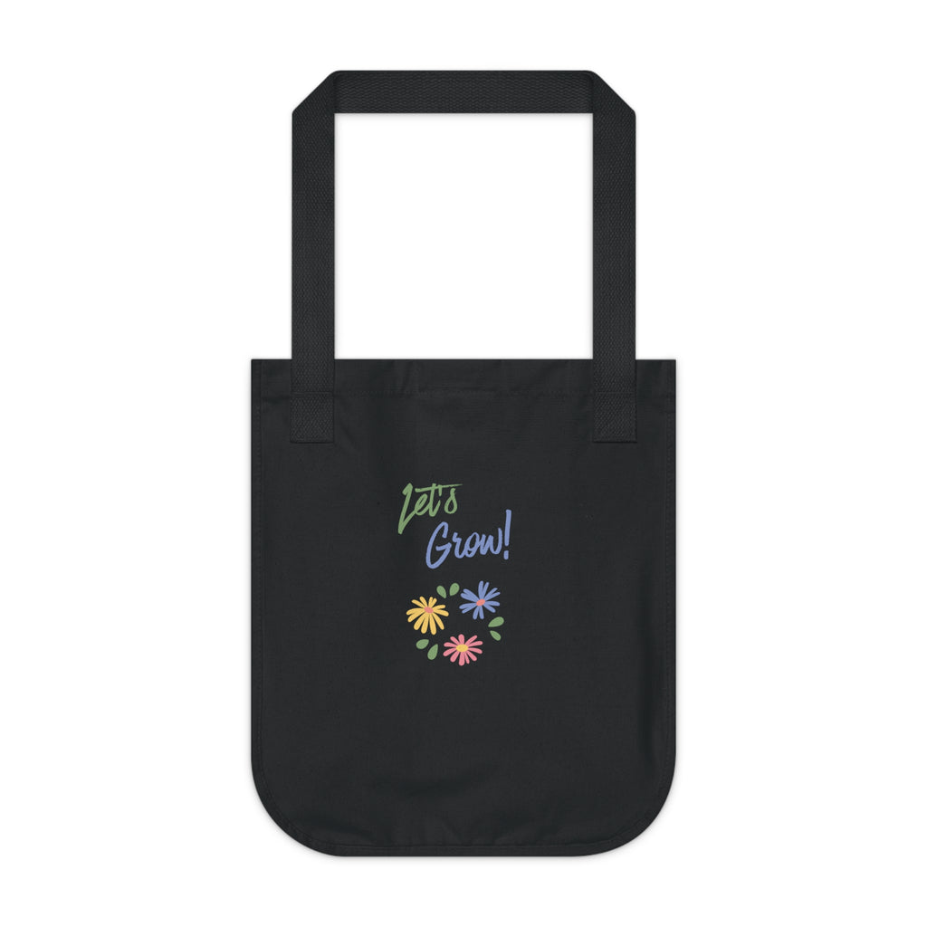 A black canvas tote bag with 'Let's Grow!' printed in green and blue script above a small cluster of colorful flowers, shown on a plain white background.
