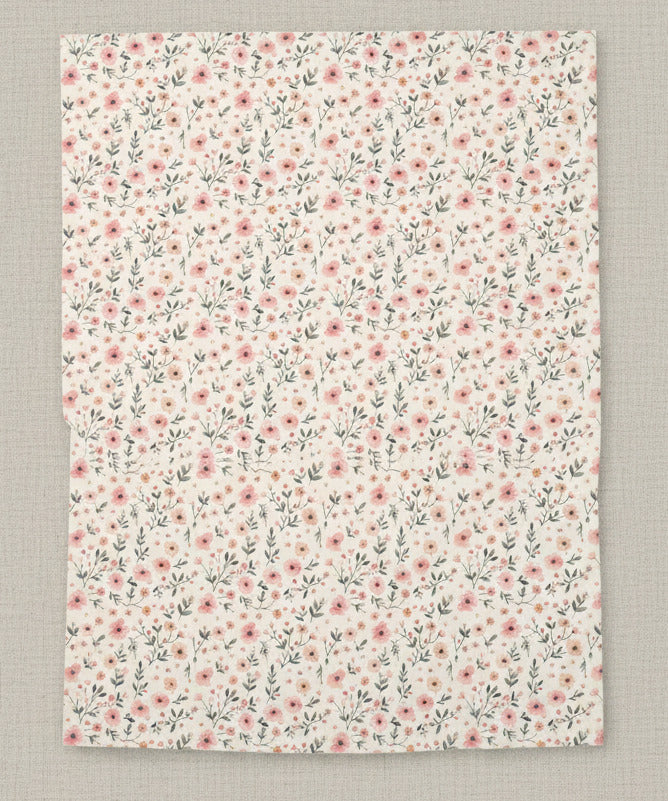 Floral patterned paper with small pink flowers on a white background