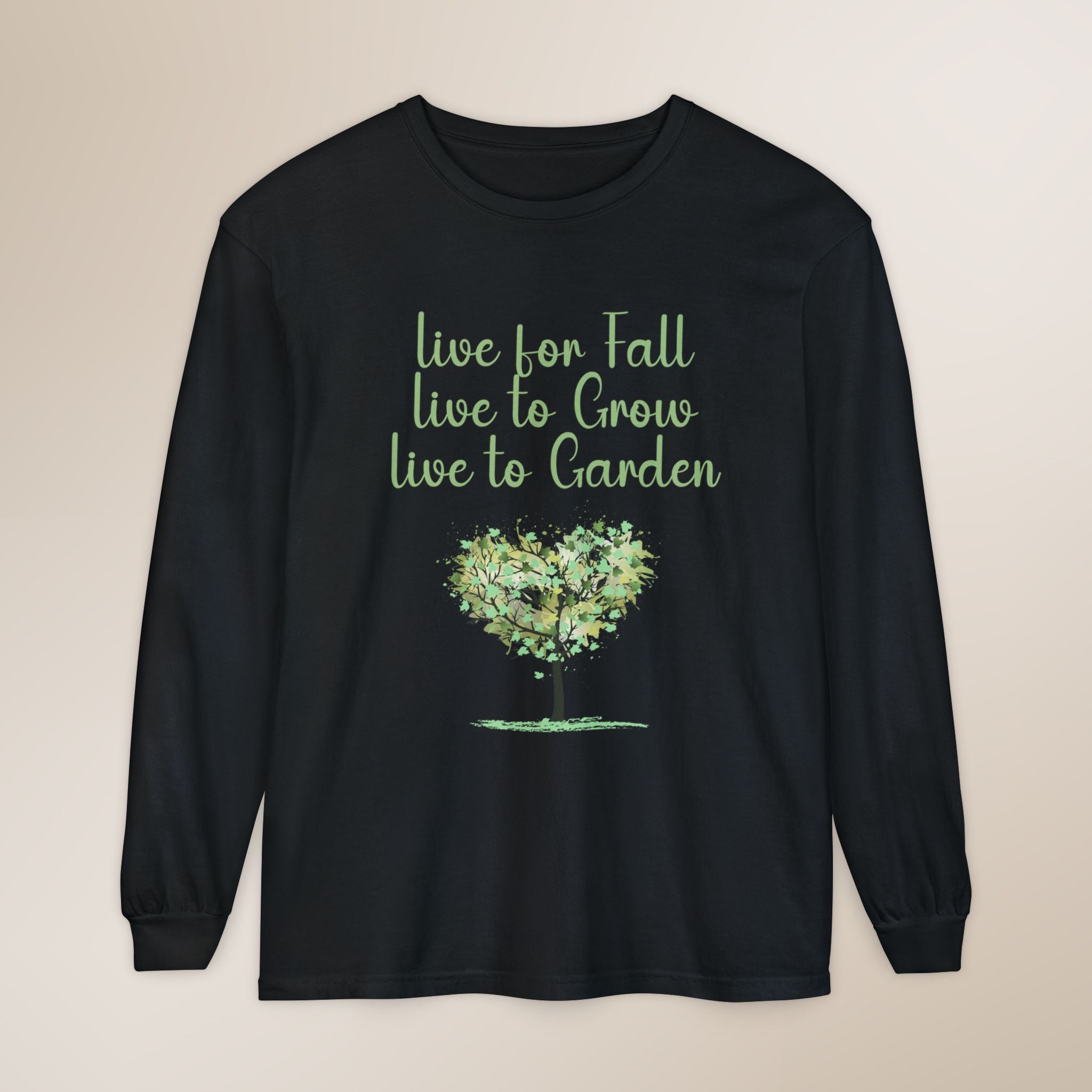 Black long-sleeve shirt with green text and tree graphic on a beige background