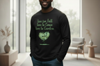 Person wearing a black sweatshirt with green text and design in a modern living room.