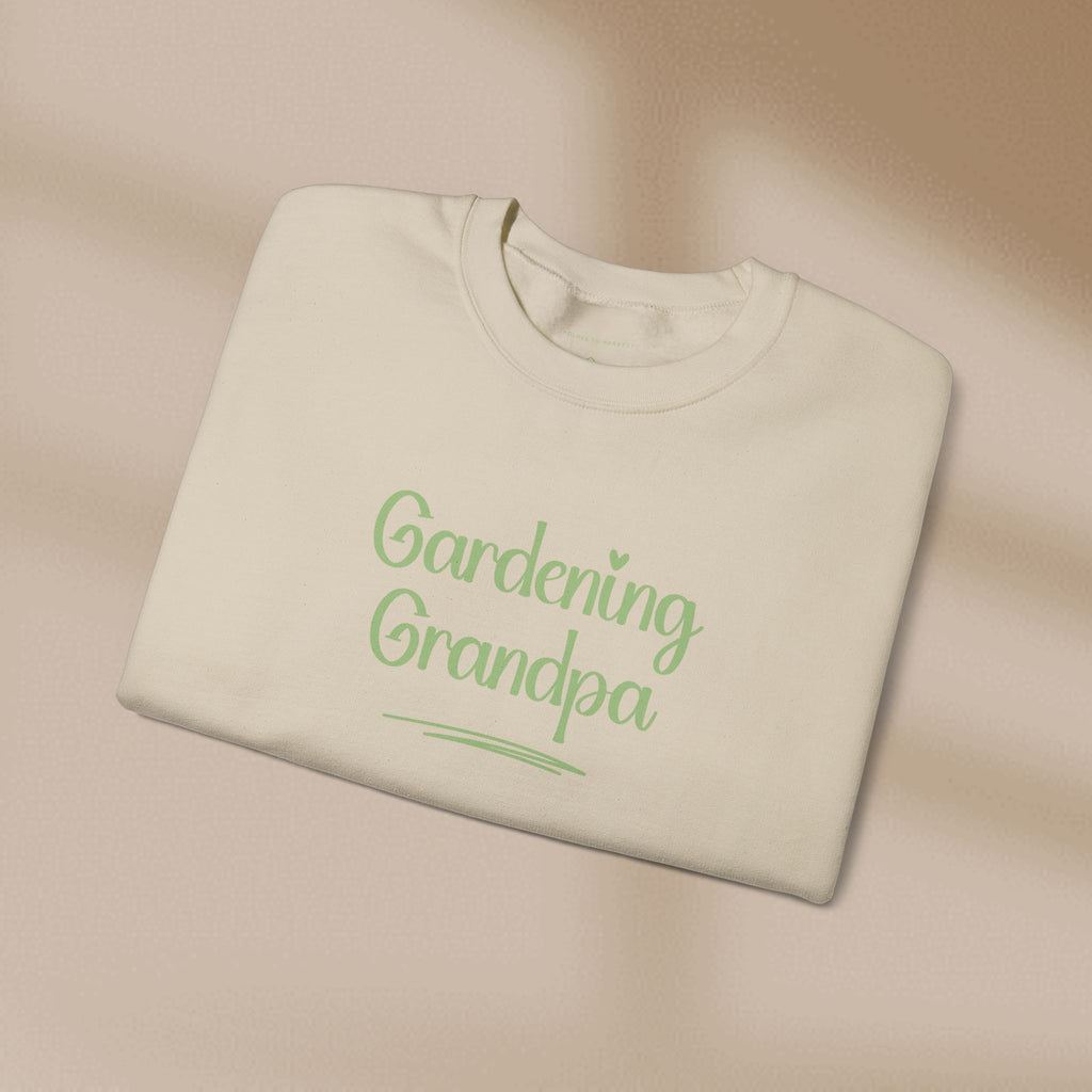 Folded beige sweatshirt with 'Gardening Grandpa' text in green on a beige background