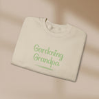 Folded beige sweatshirt with 'Gardening Grandpa' text in green on a beige background
