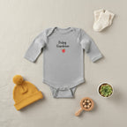 Gray baby onesie with 'Baby Gardener' text and an apple graphic on a white background