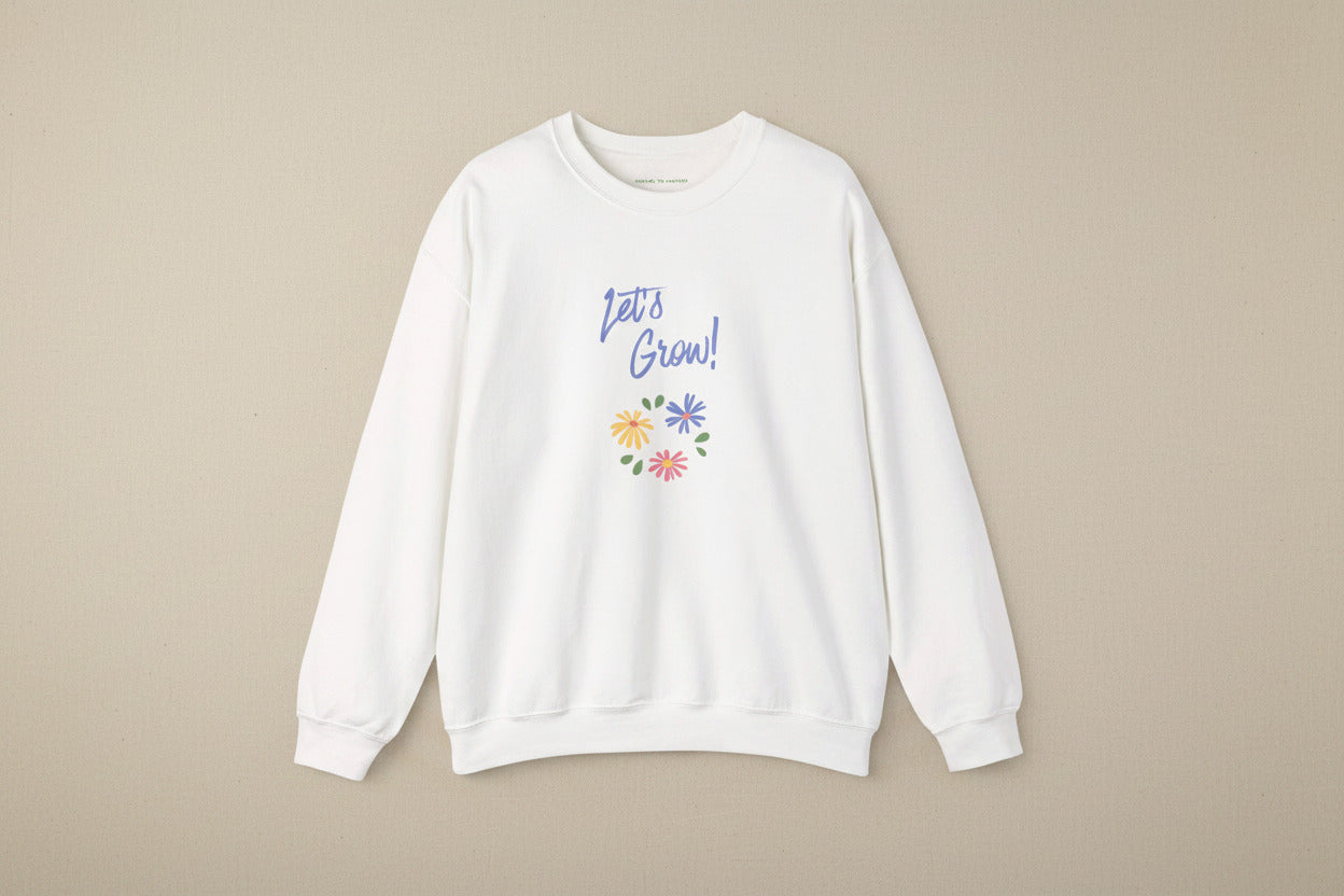 White sweatshirt with 'Let's Grow!' text and colorful flowers on a white background