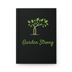 Black notebook with green tree illustration and 'Garden Strong' text on a white background