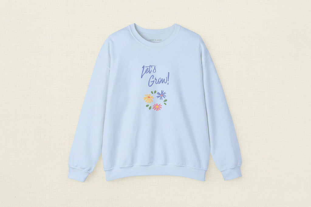 Light blue sweatshirt with 'Let's Grow!' text and floral design on a white background