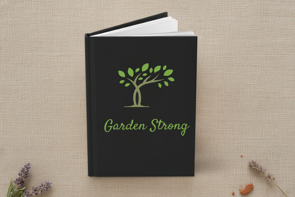 A hardcover notebook or journal with a black cover, featuring a green tree graphic and the words 'Garden Strong' in green script on the front, shown on a white background.