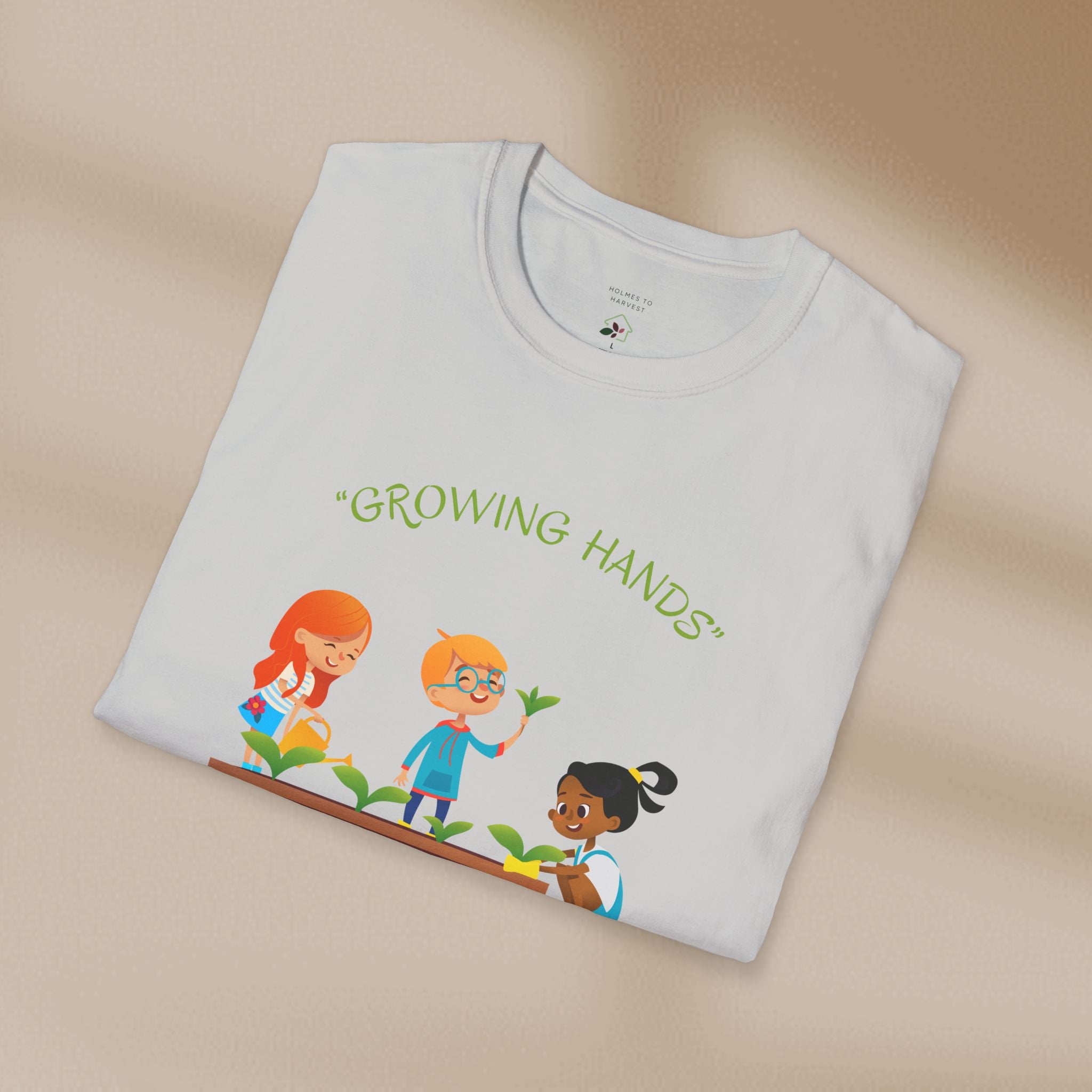 Folded t-shirt with 'Growing Hands' design on a beige background