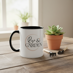 White mug with 'Rise & Garden' text on a wooden table with a potted succulent and gardening tools.
