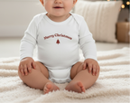 White baby onesie with 'Merry Christmas' text and tree design on a white background