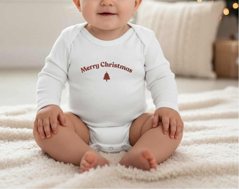 White baby onesie with 'Merry Christmas' text and tree design on a white background