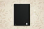 Black notebook with a QR code on a white background