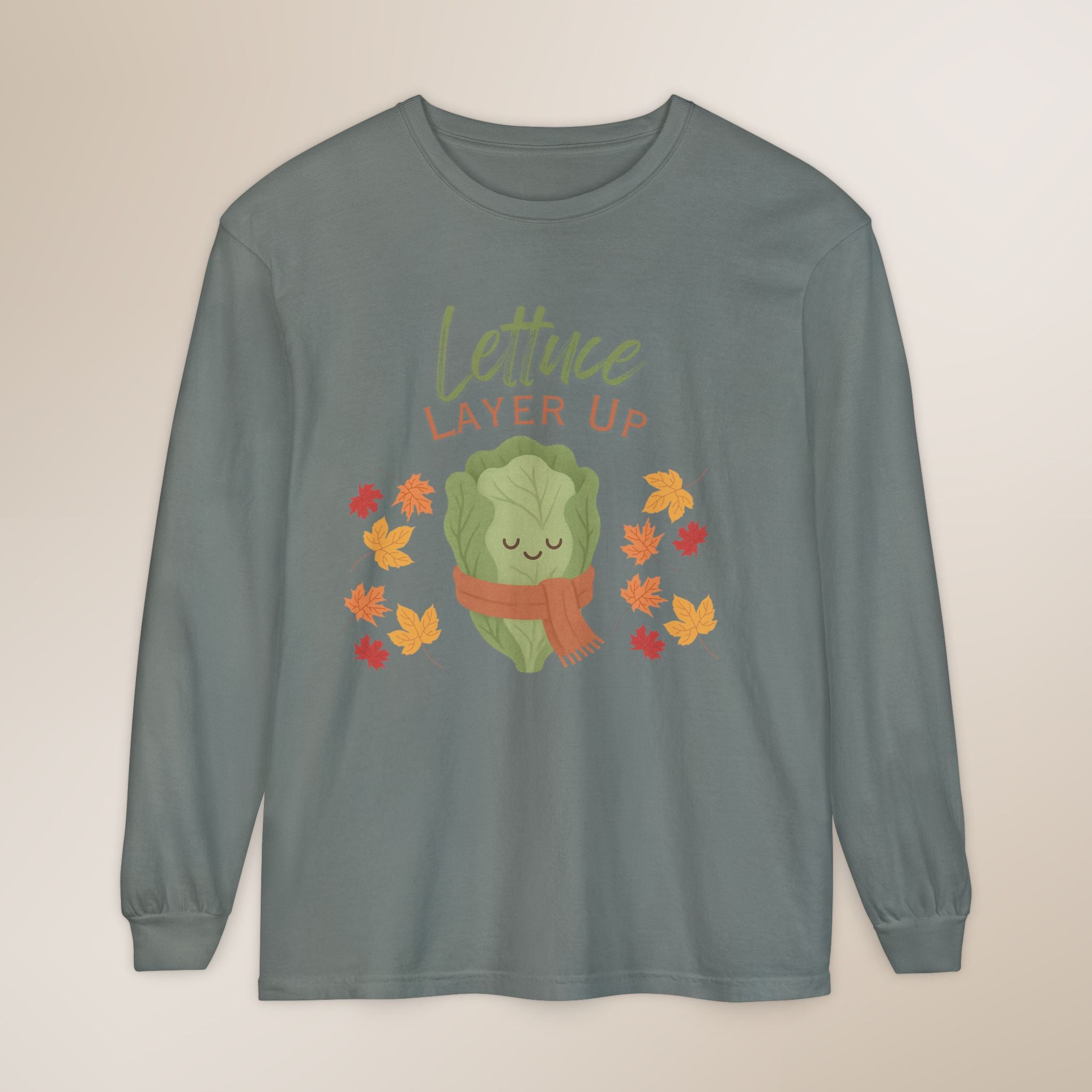Long-sleeve shirt with a cartoon lettuce character and 'Lettuce Layer Up' text on a beige background