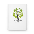 White notebook with a green tree design and text on a white background