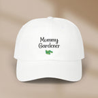 White cap with 'Mommy Gardener' text on a beige background