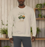 Beige sweatshirt with graphic design and text worn by a person on a white background