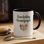White mug with 'Gardening Grandpapa' text and heart design on a wooden surface with coffee beans and a spoon.