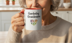 Person holding a mug with 'Gardening Grandma' text and floral design in a kitchen setting
