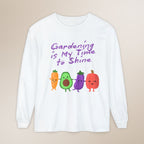 White long-sleeve shirt with cartoon vegetables and text on a beige background