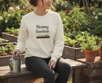 Woman wearing a 'Mommy Gardener' sweatshirt in a garden setting.