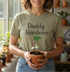 Person wearing a 'Daddy Gardener' t-shirt holding a potted plant in a home setting with plants.