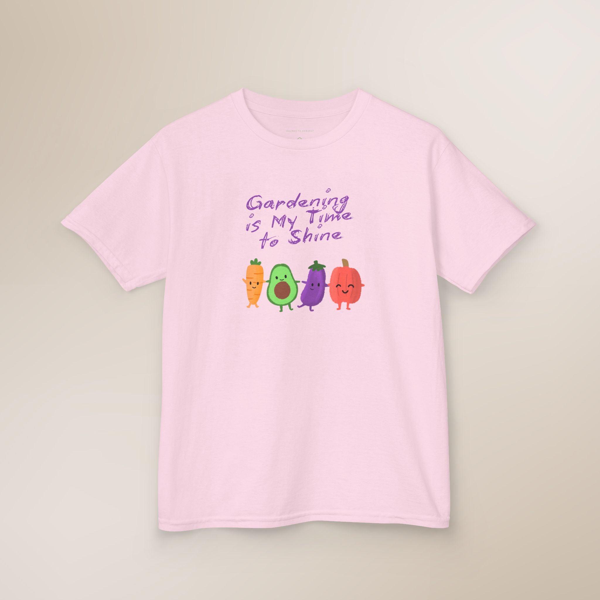 Pink t-shirt with cartoon vegetables and text on a beige background