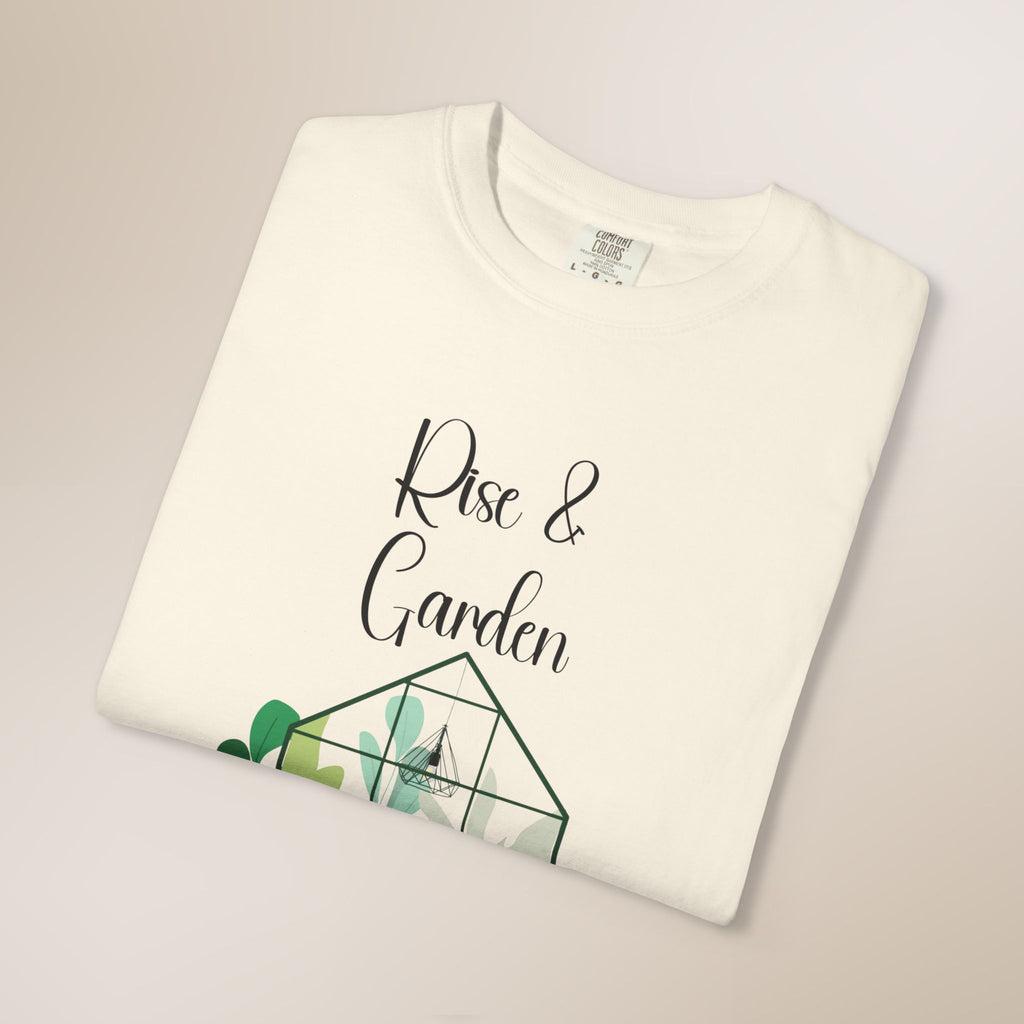 White t-shirt with 'Rise & Garden' text and geometric plant design on a light gray background