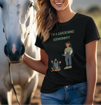 Woman wearing a black t-shirt with a graphic design standing next to a horse.
