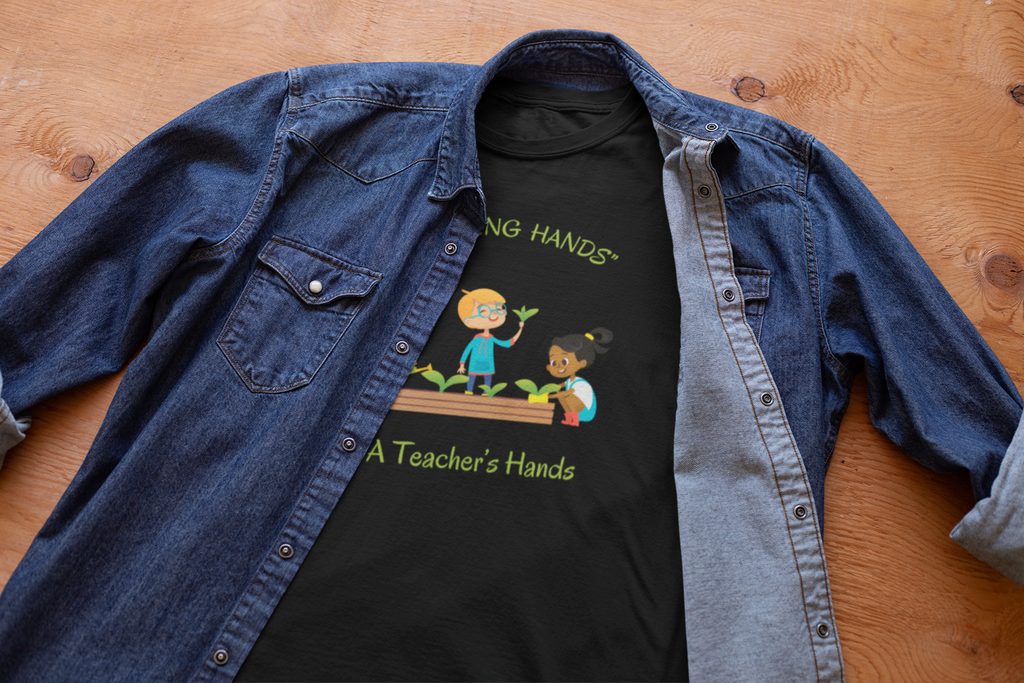 Black t-shirt with graphic design and text 'Inching Hands, A Teacher's Hands' on a blue denim shirt.