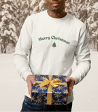 Man holding a Christmas gift in front of a decorated tree and 'Merry Christmas' banner.
