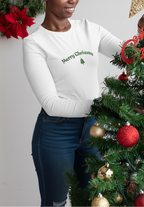 Woman decorating a Christmas tree with a gold star and red ornaments, wearing a 'Merry Christmas' sweater.
