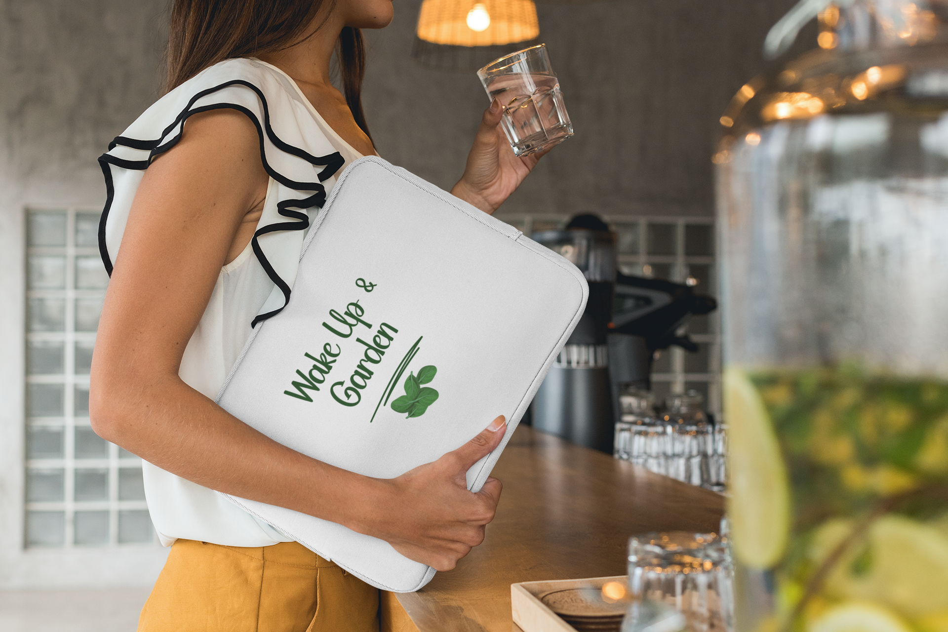 Person holding a white tote bag with text and graphics in a kitchen setting