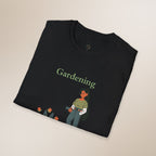 Black t-shirt with 'Gardening' text and gardening-themed design on a beige background