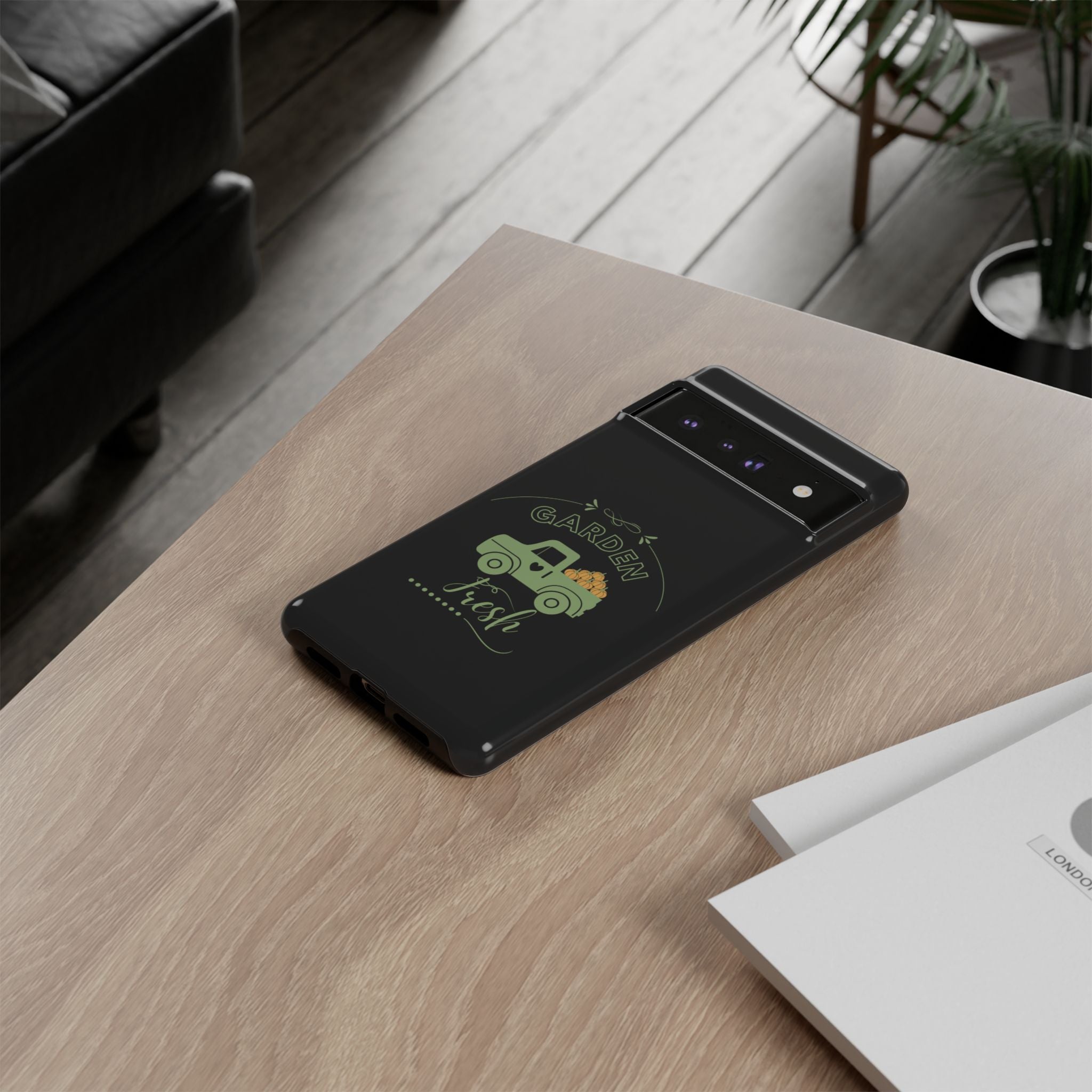 Phone case with a green design on a wooden table