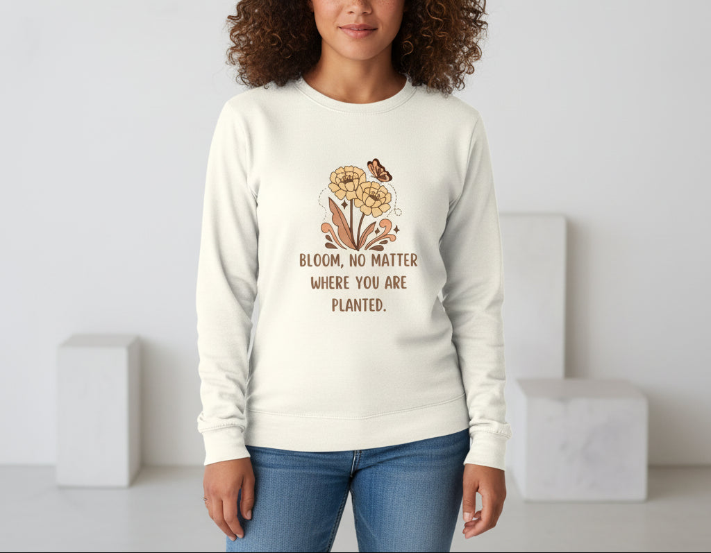 White long-sleeve shirt with floral design and text on a beige background