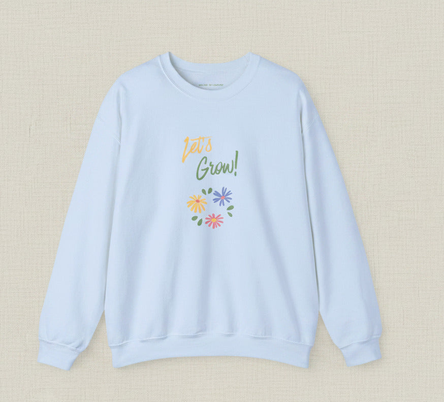 Light blue sweatshirt with 'Let's Grow!' text and floral design on a white background