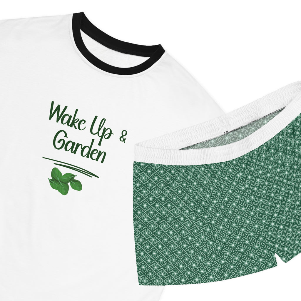 White t-shirt with black trim and green patterned shorts on a white background