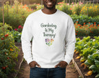 White sweatshirt with 'Gardening is My Therapy' text and heart design on a beige background