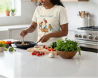 Person cooking in a kitchen wearing a t-shirt with cartoon characters and text.