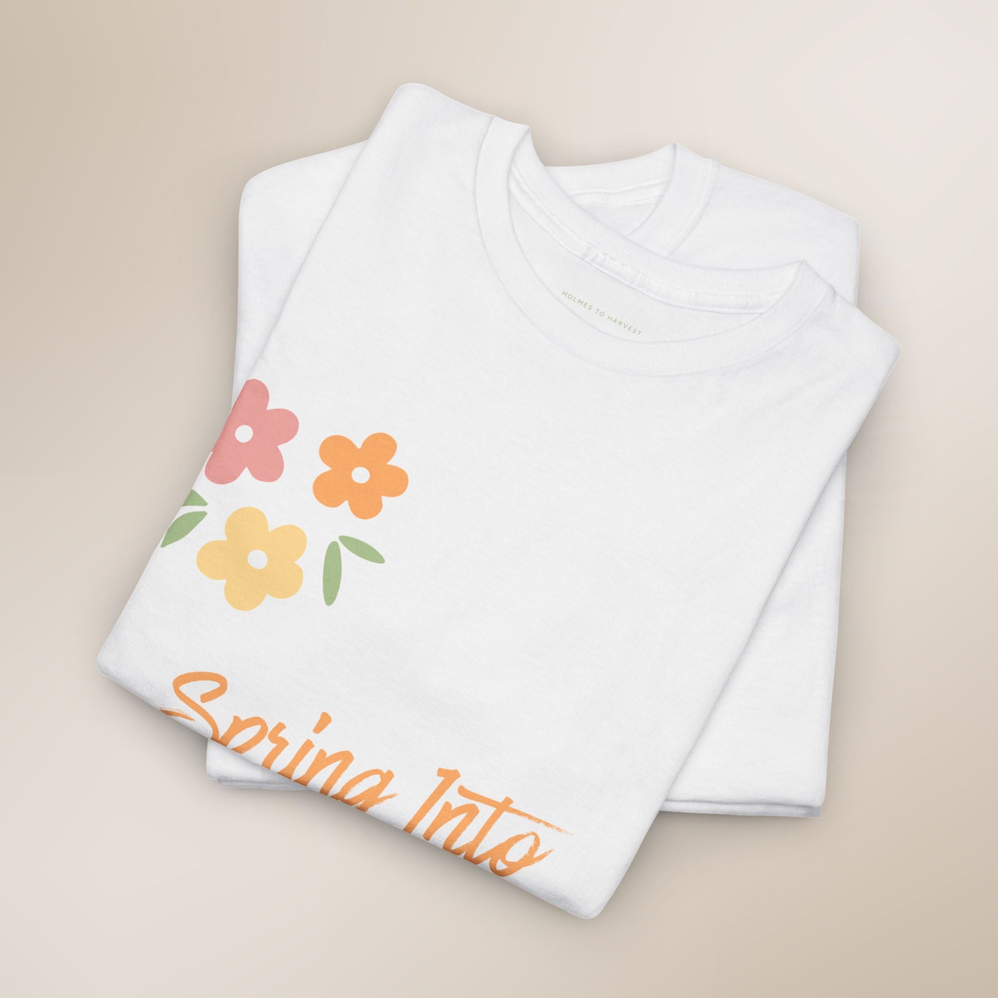 White shirt with colorful floral design and 'Spring Into' text on a beige background