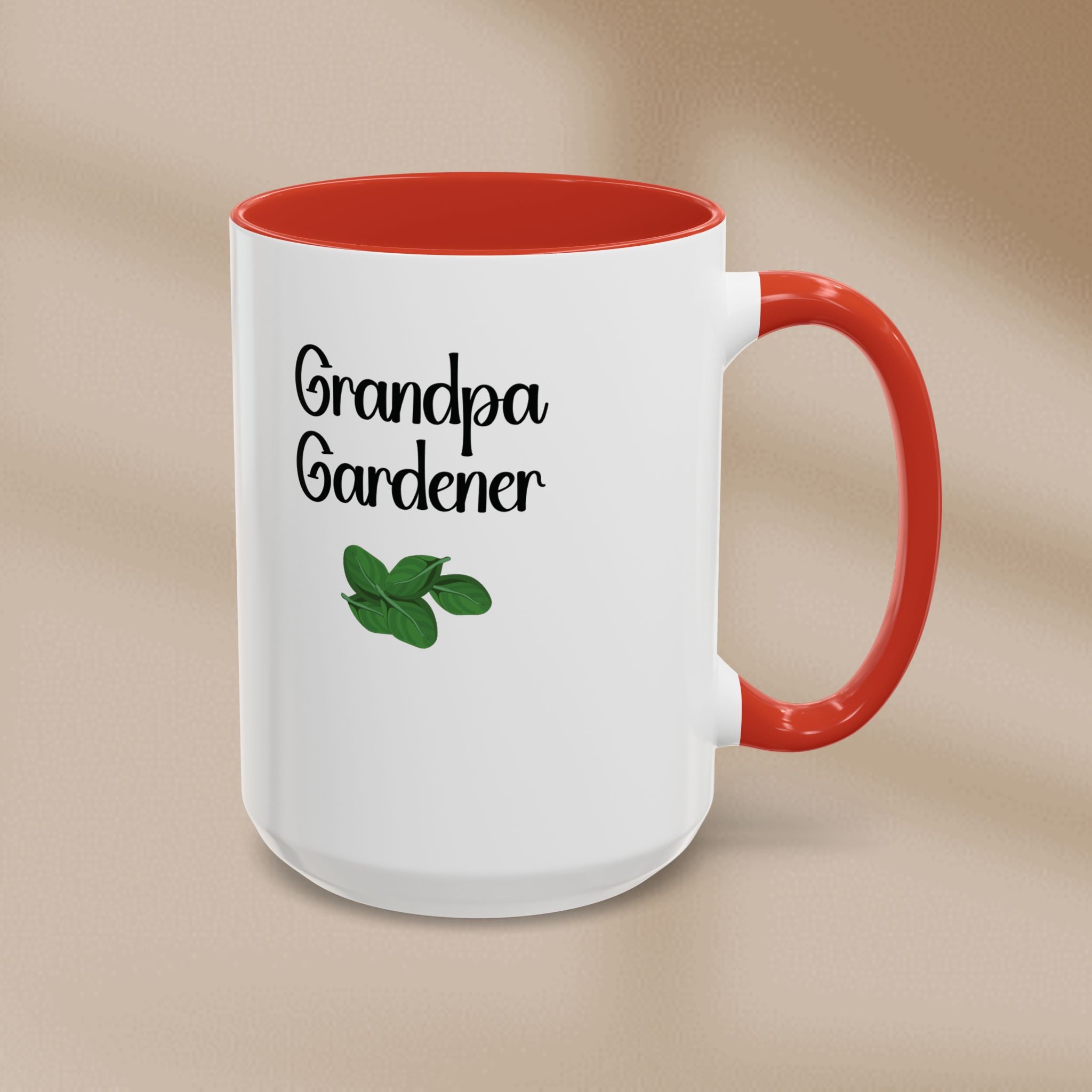 White mug with red interior and handle, featuring 'Grandpa Gardener' text and a leaf graphic on a beige background.