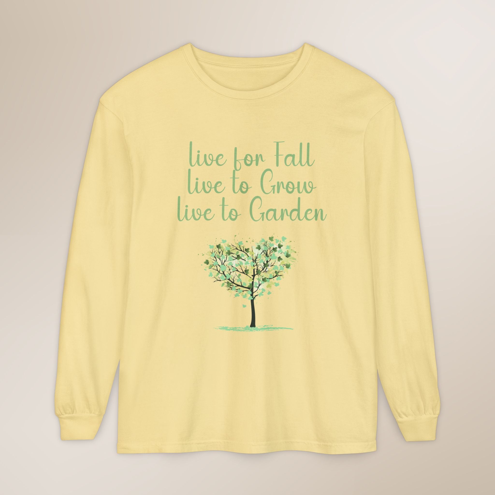 Yellow long-sleeve shirt with a tree graphic and text on a beige background
