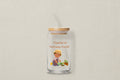 Glass tumbler with a bamboo lid featuring an illustration of a person gardening and text on a white background.