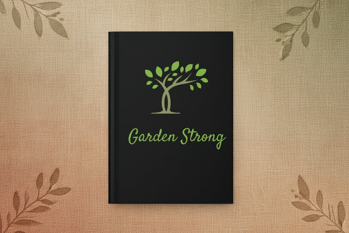 A black hardcover notebook with a green tree graphic and the words 'Garden Strong' printed on the front, shown against a plain white background.