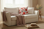 Floral patterned pillow with red and pink flowers on a white background