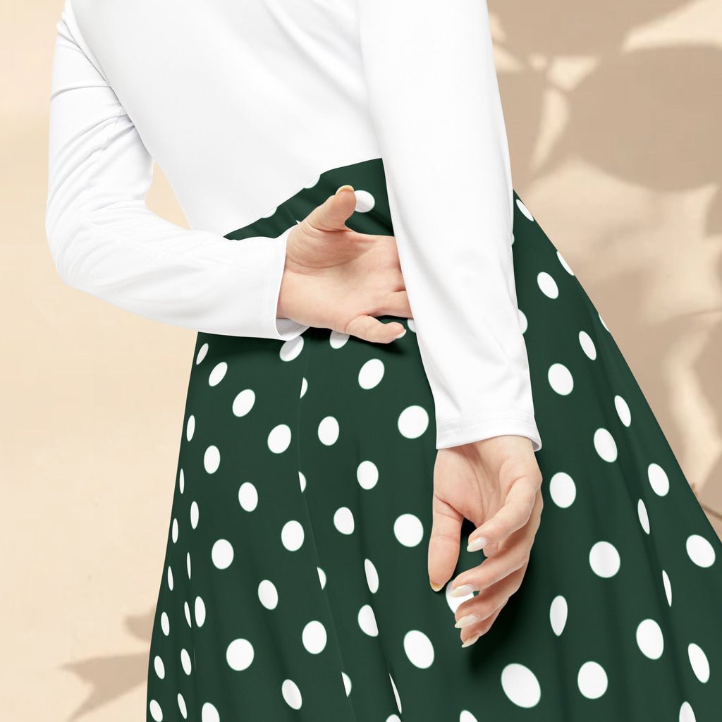 Green polka dot skirt with white long-sleeve top on a beige background