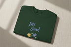 Folded purple shirt with white graphic and text on a white background