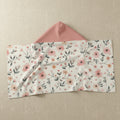 Floral-patterned envelope with a pink interior on a white background
