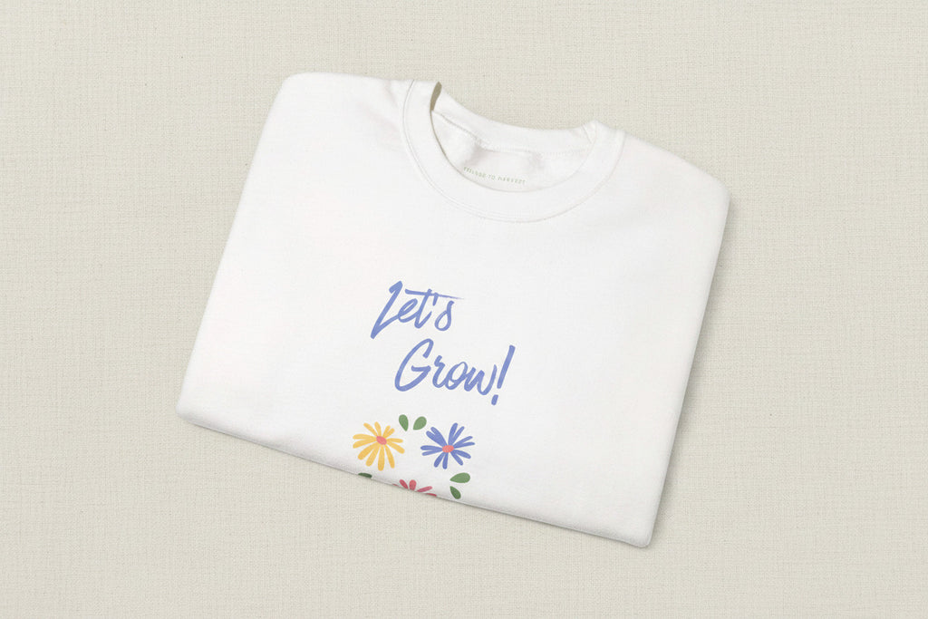 White shirt with 'Let's Grow!' text and floral designs on a white background